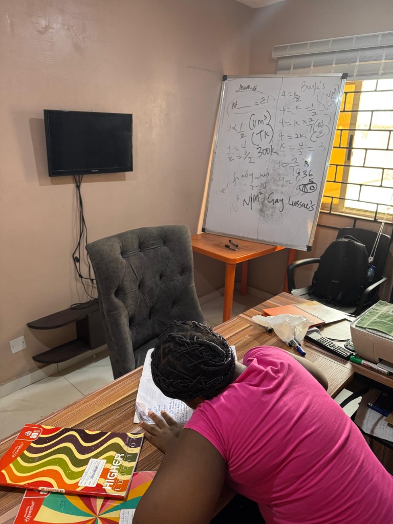 Student studying Maths with whiteboard notes at Dr. J Tutors