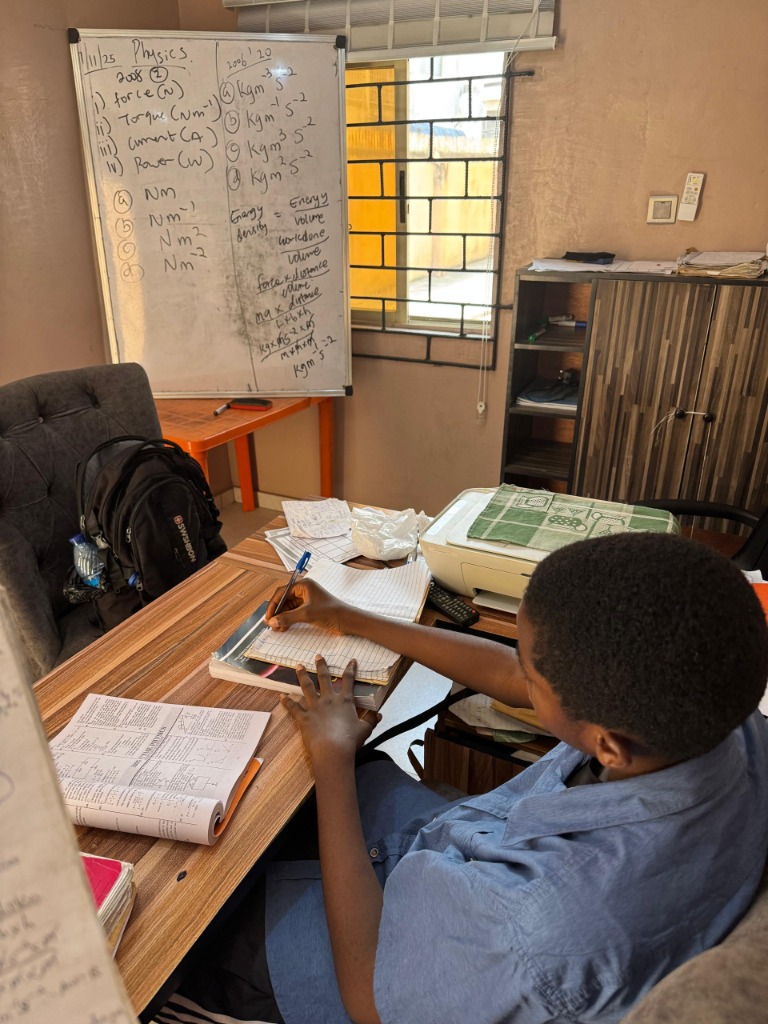 Student working through Physics problems at Dr. J Tutors